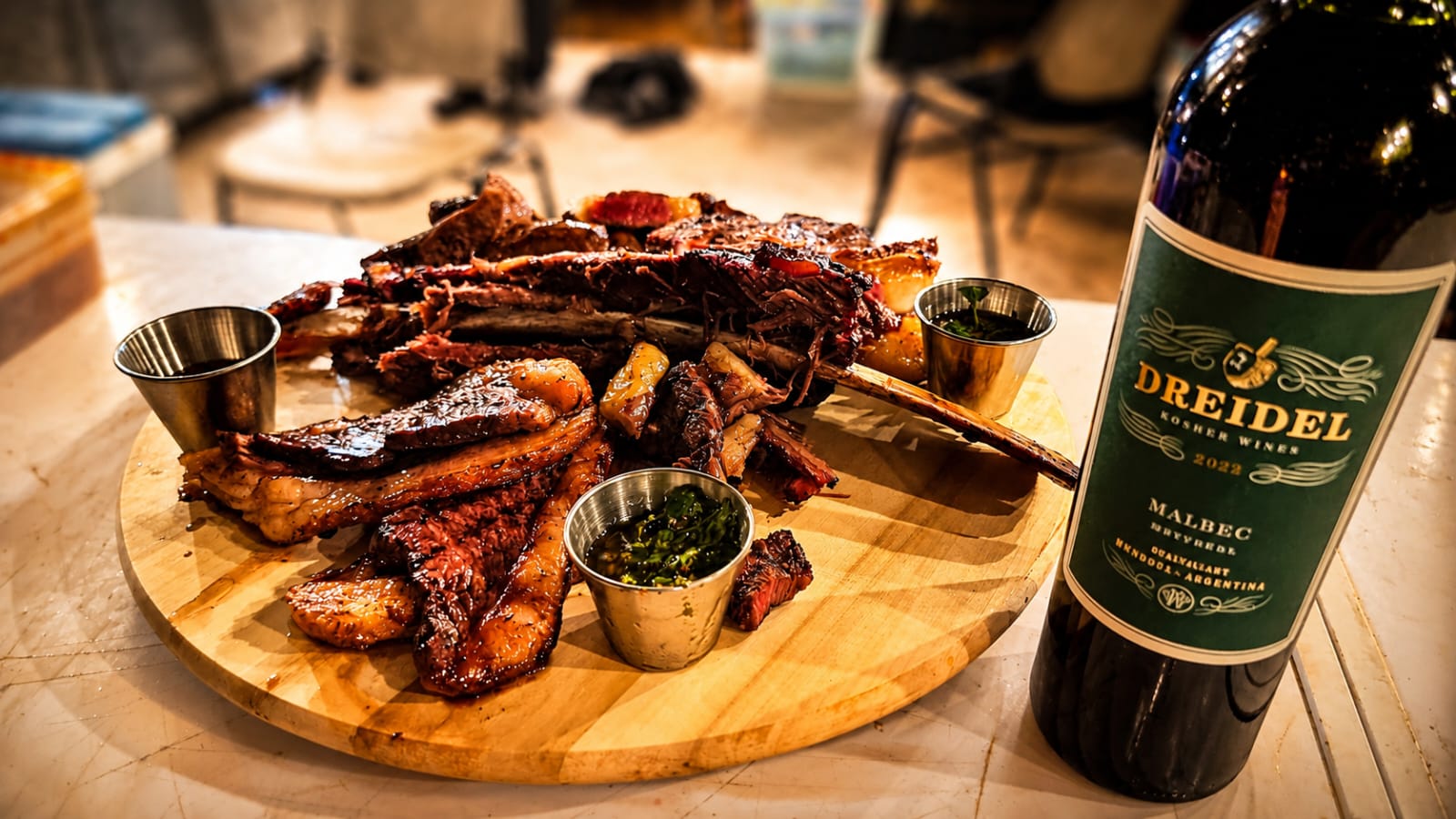 Asado board of ribs and brisket with chimichurri and Argentinian Malbec at Rancho Asado