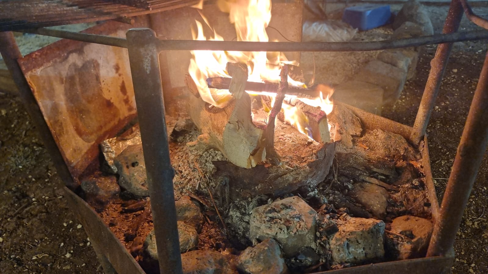 Logs burning in the open fire pit at the ranch