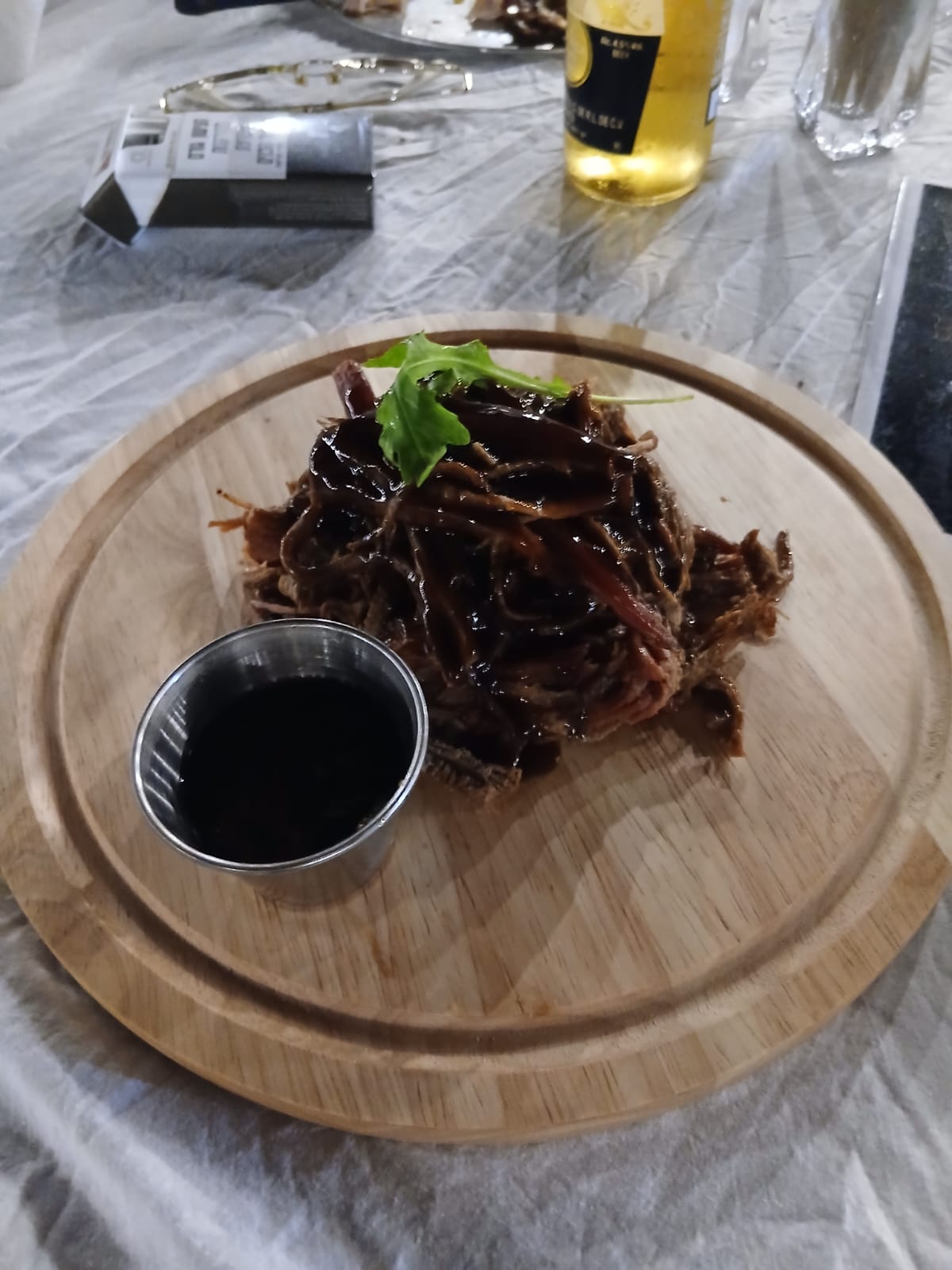 Pulled brisket in reduced BBQ sauce on a wooden board